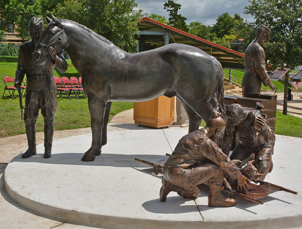 Bronze monument depicting 4 scenes representing the Veterinary Corps history and primary missions