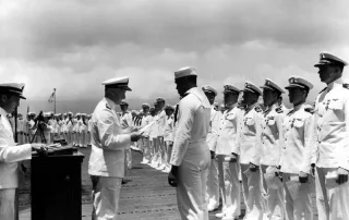 Adm. Chester Nimitz awards the Navy Cross medal to Mess Attendant 2nd Class Doris Miller for his actions aboard the battleship USS West Virginia (BB-48) during the Dec. 7, 1941 Japanese attack on Pearl Harbor